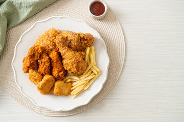 fried chicken with french fries and nuggets on plate