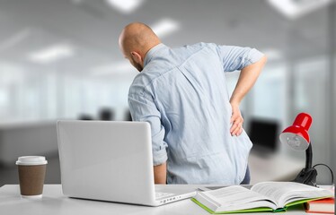 Young businessman working, having back pain