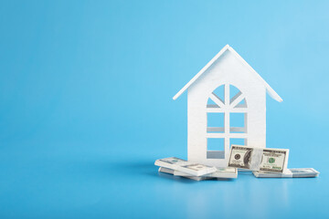 house and money, dollars banknotes and real estate, mortgage loan for construction and purchase of...