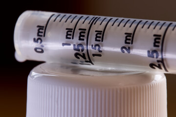 Macro Close-Up of Antibiotic Syringes laying on white plastic cap. Recovering from infection. 