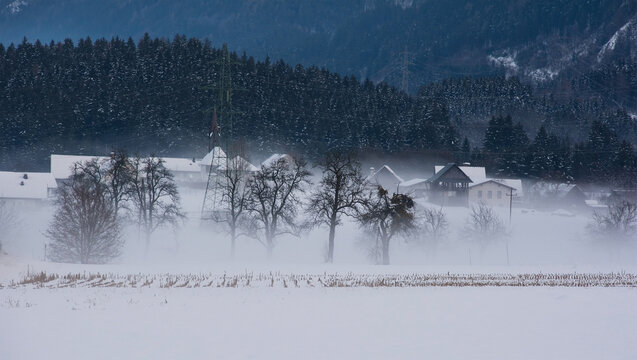 The foggy and snowy winter landscape near Pockau in Arnoldstein, Carinthia, Austria
