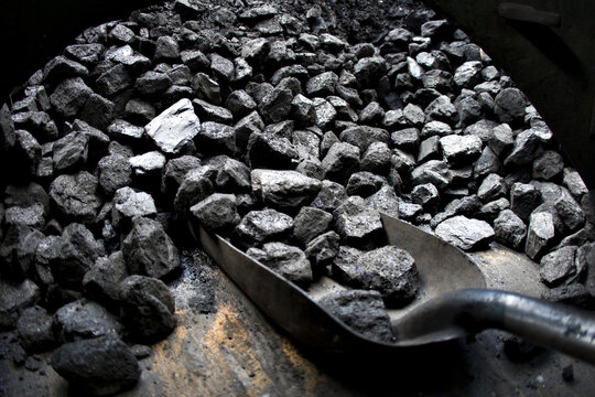 An Old Shovel And Piles Of Coal In A Vintage Steam Train Or Locomotive.