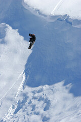 A snowboarder launches off a cornice while riding in the back country slopes of the Maluti Mountains in Lesotho in Africa.