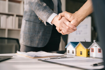 Fototapeta na wymiar Close up two men shake hands at office negotiations. Making deal sign, conclude contract, formal greeting, strike bargain. Successful negotiations, insurance home loan concept.