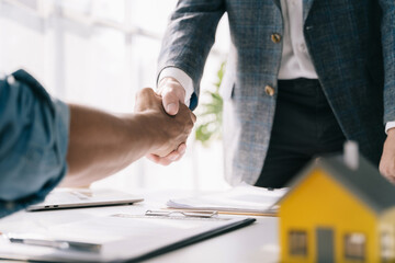 Close up two men shake hands at office negotiations. Making deal sign, conclude contract, formal greeting, strike bargain. Successful negotiations, insurance home loan concept.