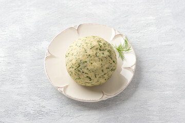 Raw dough for cheese gnocchi or dumplings with herbs and cheese on a light gray background, top view. Cooking delicious homemade gnocchi
