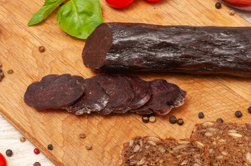 Horse sausage mahan sliced on a wooden board top view