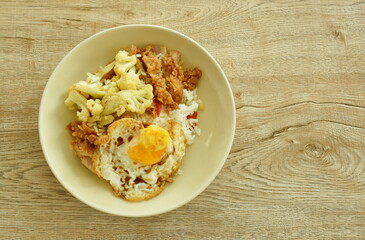stir fried cauliflower with crispy chicken and egg topping plain rice on plate
