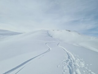 Fototapeta na wymiar Ski touring in deep snow. Beautiful trail in deep snow. Mountain landscape