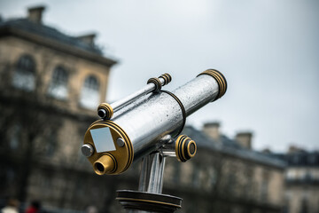 Telescope. City spyglass. Telescope overlooking Notre Dame. View point with telescope on the Notre Dame. - Powered by Adobe