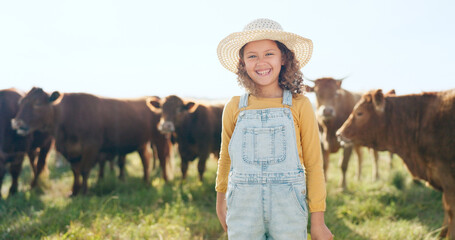 Happy child, farming and fun learning to care for animals, cows and cattle during nature travel in...