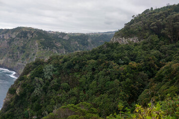 The green mountains of Madeira Island on a cloudy foggy day.