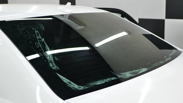 Car window tinting series: Installation of car window tinting. Detailing studio.