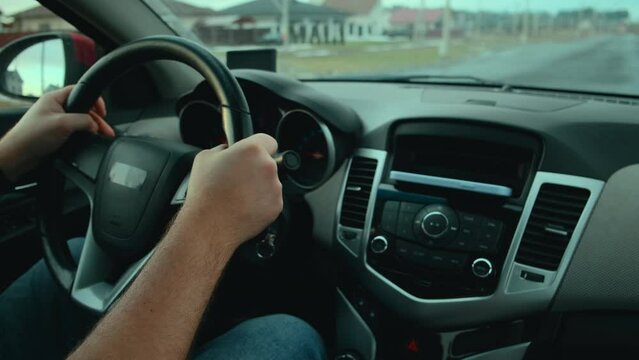 Hands unrecognizable Man driver control the radio or music on the road while driving a car in motion