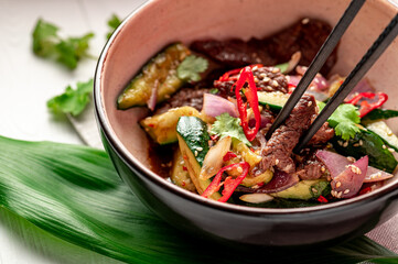 Fried veal with hot chili with onion, cucumber, sesame seeds with soy sauce