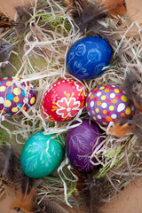 Easter wreath of vines and colored eggs background. Festive decor. Spring holiday decoration. Decorated colorful ster egg. Wreath of branches willow twigs. © Real_life