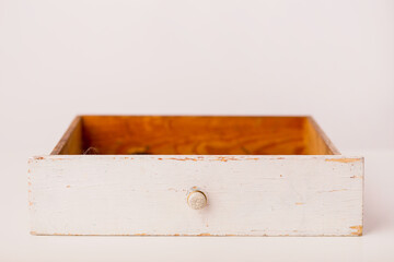 Closeup of a white vintage drawer on a white background