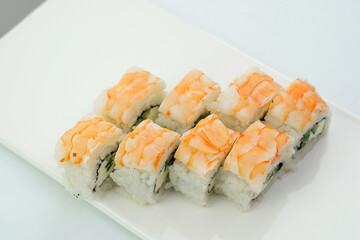 Space for text Sushiya restaurant Asia Japan delicious food healthy Roll Philadelphia with shrimp on a white plate eight pieces cucumber avocado Philadelphia cheese