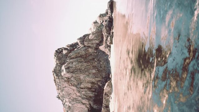 vertical view of sea landscape with turquoise water and tropical rock island