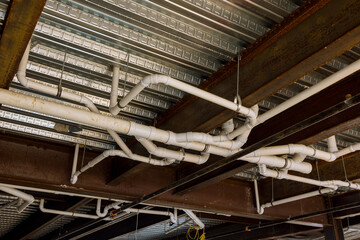 Installation an assembled in waste pipe lines system under ceiling of apartment building complex was completed