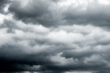 Obraz premium dark clouds make sky in black. Heavy rain thunderstorm. Pattern of clouds overcast predict tornado, Hurricane or thunderstorm and rainy. Dark sky cloudy have storm and lightning thunderbolt.