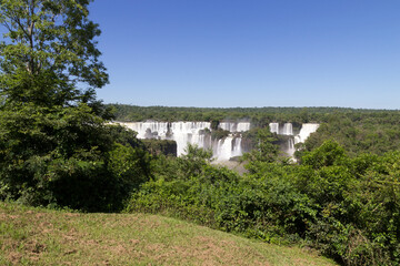 Fototapeta na wymiar Iguazu Falls, monumental waterfall system on Iguazu River surrounded by lush green jungle - Brazil/Argentina border, South America.