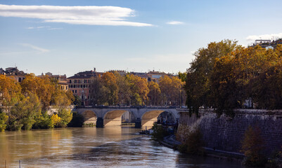Fototapeta na wymiar River Tiber and Bridge in a historic City, Rome, Italy. Sunny and Cloudy day.