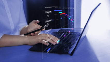 Manager working and updating tasks and milestones progress planning with Gantt chart scheduling interface for company on virtual screen.	

