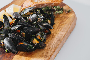 boiled mussels with parsley, spinach, Asian herbs and lemon and toasted baguette