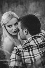couple in love blonde girl and guy in the grass