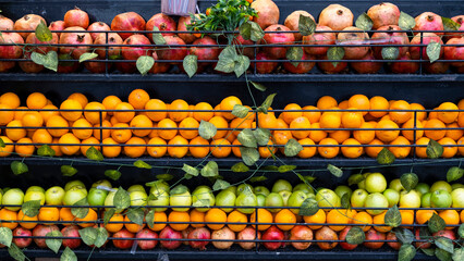 Fruits lined up on the shelves, Orange, Pineapple, Pomegranate, Apple, Mango, Tangerine