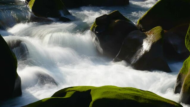 White turbulent streams. Oddly shaped rocks with some moss growing on them. Pothole structure in the Keelung River Basin. Taiwan