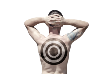 A man with a target drawn on his back holds his hands on the back of his head (isolated)