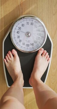 woman measure weight on scale