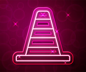 Glowing neon line Traffic cone icon isolated on red background. Vector