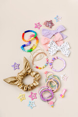 Set of baby girl hair accessories. Fashion hair bows, hair clips, hairpins and hair elastics.  Hairstyles for girls with stylish accessory.