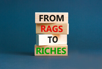 Rags or riches symbol. Concept words From rags to riches on wooden blocks. Beautiful grey table grey background. Business rags or riches concept. Copy space.