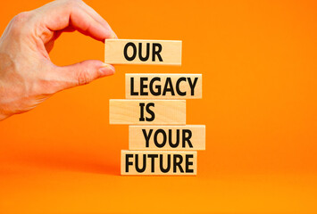 Legacy and future symbol. Concept words Our legacy is your future on wooden blocks. Beautiful orange table orange background. Businessman hand. Business legacy and future concept. Copy space.