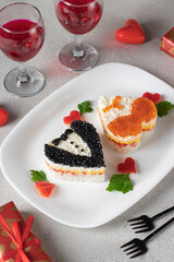 Festive salad in shaped hearts for Valentine's Day decorated with red and black caviar