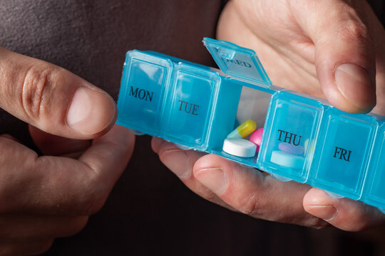 Man take pills from box. Healthcare and old age concept with medicines. Medicaments on table.