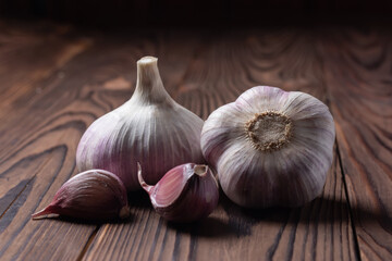 Garlic cloves and bulb on wooden table. Fresh peeled garlics and bulbs.