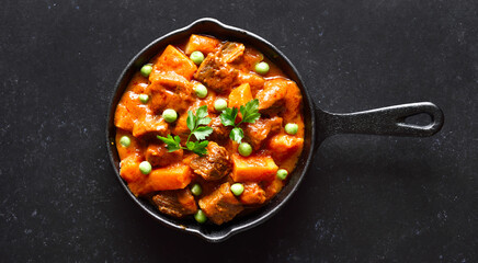 Beef stew with potatoes and carrots in tomato sauce