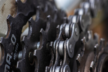 Cassette and chain of a mountain bike close-up on a black background.