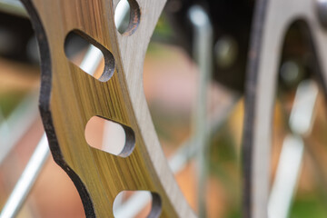 Bicycle disk brake rotor in focus. Metal details of transport concept