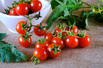 Cherry tomatoes, Bunch of fresh, red tomatoes with green stems, Selective focus.