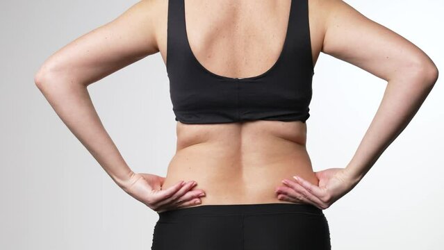 Woman checks the flabby skin. Body control