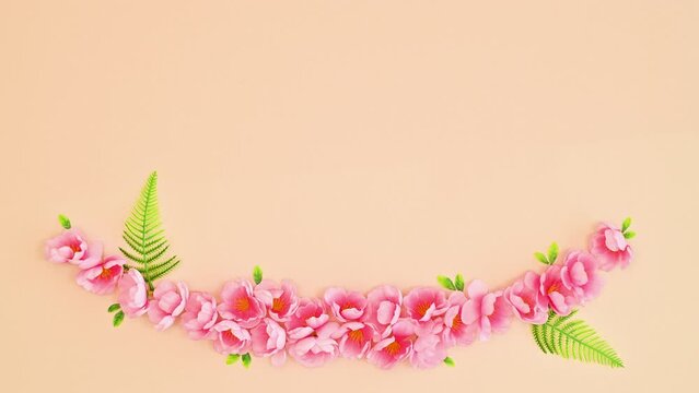 Beautiful floral garland stop motion. Paint brush leaving behind bloom spring flowers. Flat lay