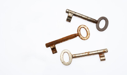 three old rusty key on white background,