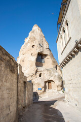 A narrow street and cave hotel in the town of Goreme.