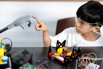 Asian boy is touching his finger The robot model being tested